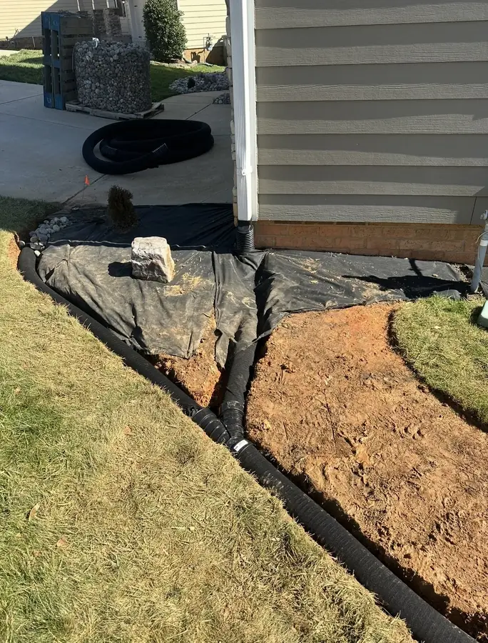 Downspout tied into a buried drain line
