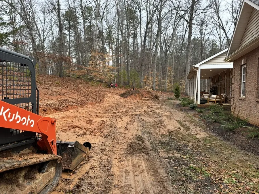 Regrading a side yard with a track loader