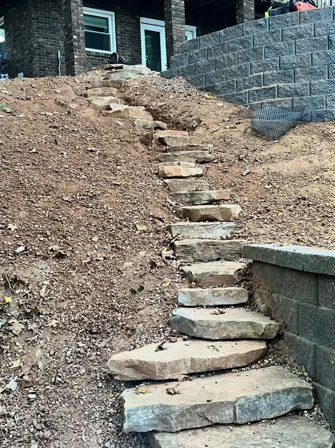 Natural stone steps beside a block retaining wall