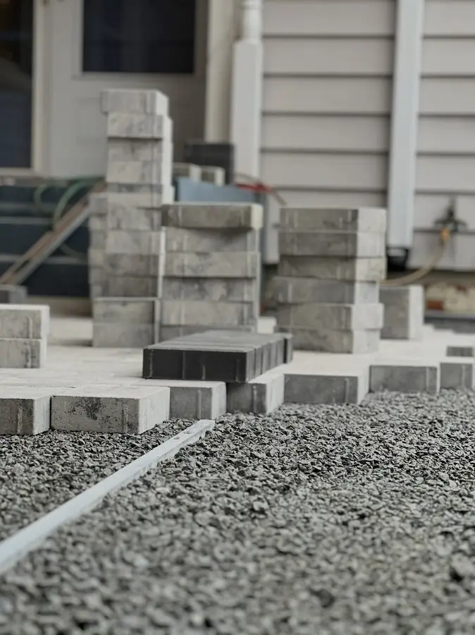 Crushed stone base and pavers staged for a patio