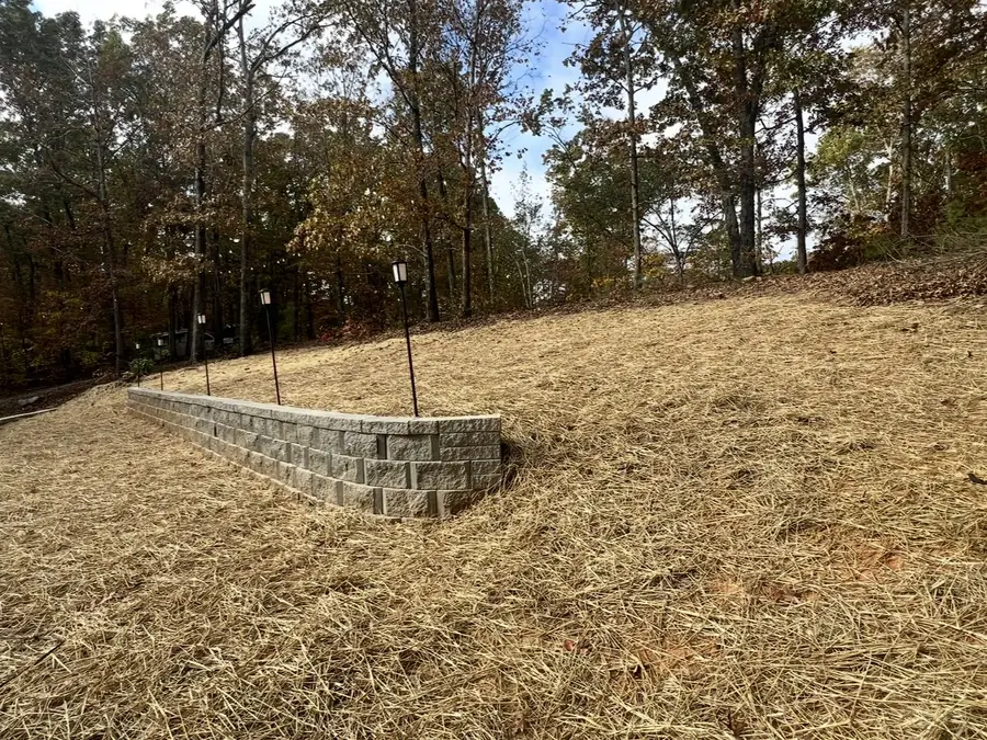Block wall holding a regraded slope