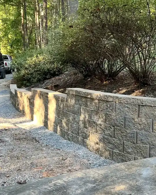 Stone walls stepping up a planted hill
