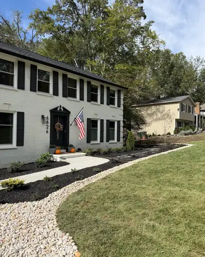 New beds, river rock and sod in a front yard