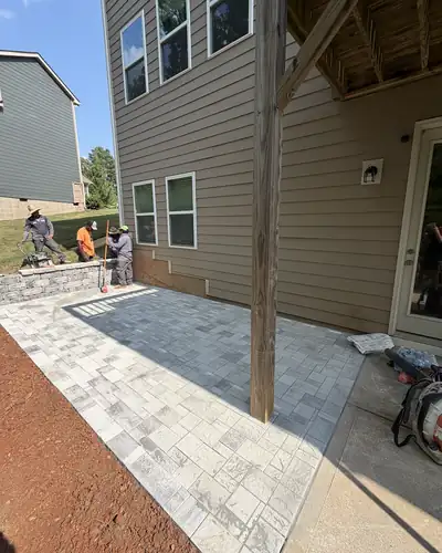New paver patio under a back deck