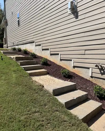Stone steps up a hillside beside a home